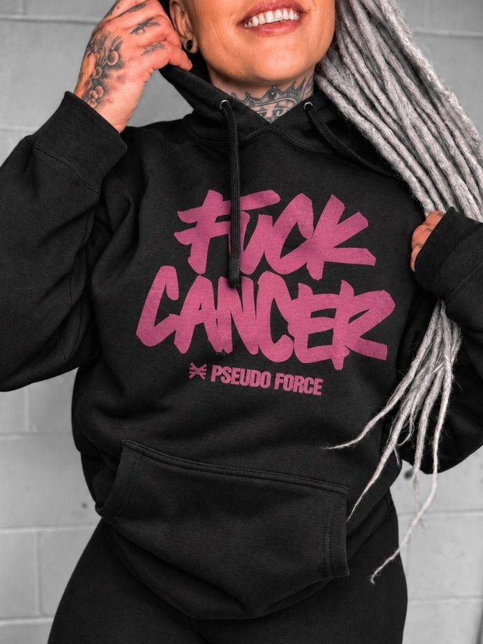 woman in black hoodie with white background. the hoodie says "fuck cancer" in a pink font with pseudo force logo and name underneith. 