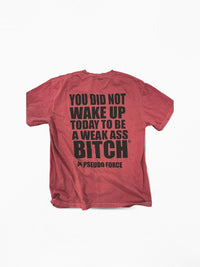 Red t-shirt with black text on a white background. Text says "you did not wake up today to be a weak ass bitch" with a registered trademark symbol and brand pseudo force with logo.
