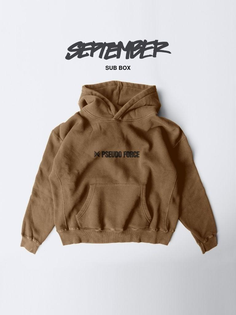 A brown hoodie with a kangaroo pocket and a black 'PSEUDO FORCE' logo on the chest, displayed flat against a light gray background with 'SEPTEMBER SUB BOX' text above.