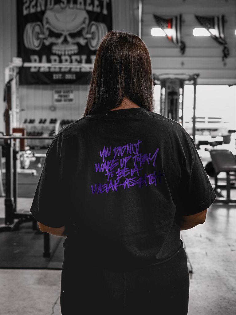 woman wearing pseudo force black crop tee with purple lettering of You Did Not Wake Up Today To Be A Weak Ass Bitch.