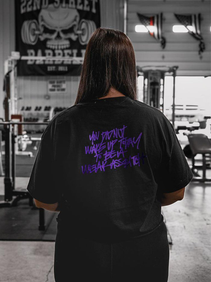 woman wearing pseudo force black crop tee with purple lettering of You Did Not Wake Up Today To Be A Weak Ass Bitch.