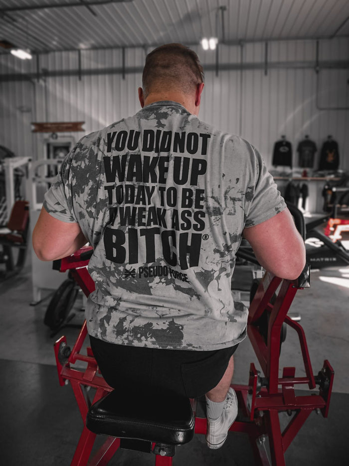 A man doing rows wearing a motivational gym shirt that says You Did Not Wake Up Today To Be A Weak Ass Bitch from Pseudo Force brand.